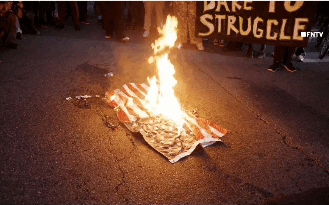Rioters in Los Angeles seen spitting on and burning American flags